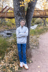 Littleton family photographer Morrison Park Colorado fall leaves color foothills photography brothers mother father sons bridge river