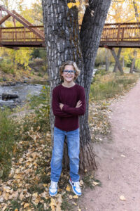 Littleton family photographer Morrison Park Colorado fall leaves color foothills photography brothers mother father sons bridge river
