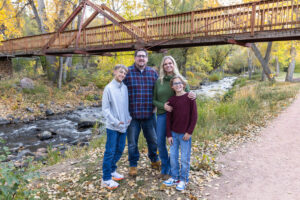 Littleton family photographer Morrison Park Colorado fall leaves color foothills photography brothers mother father sons bridge river