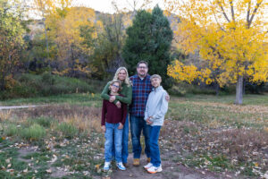 Littleton family photographer Morrison Park Colorado fall leaves color foothills photography brothers mother father sons bridge river