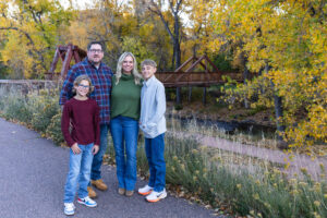 Littleton family photographer Morrison Park Colorado fall leaves color foothills photography brothers mother father sons bridge river