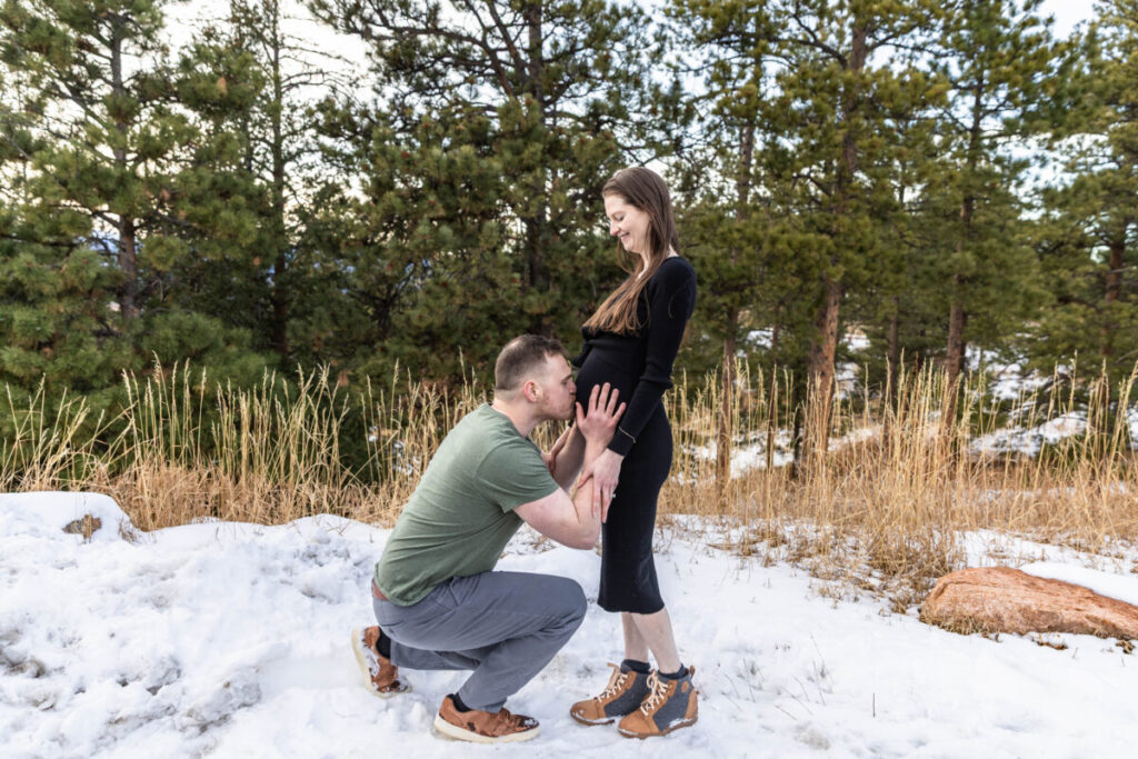 Kissing the baby bump.