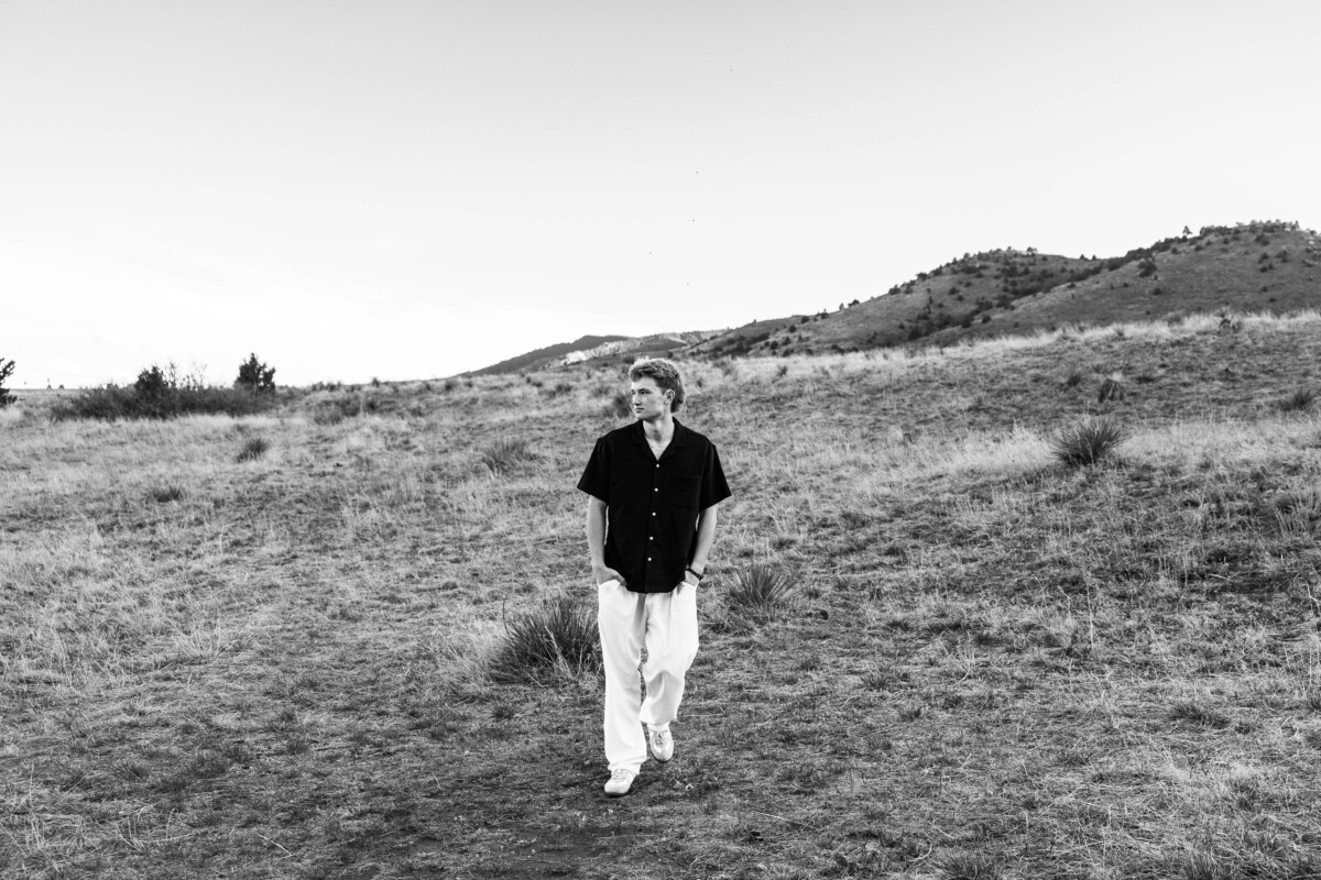 Senior boy walking at Red Rocks for his photography session