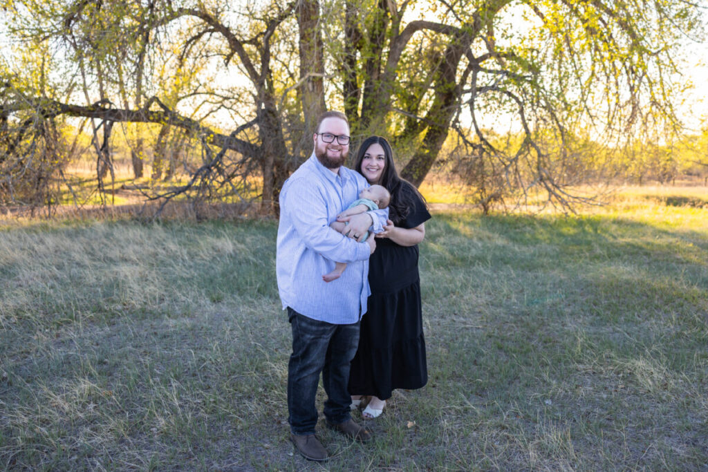 Colorado family photographer with a baby at sunset