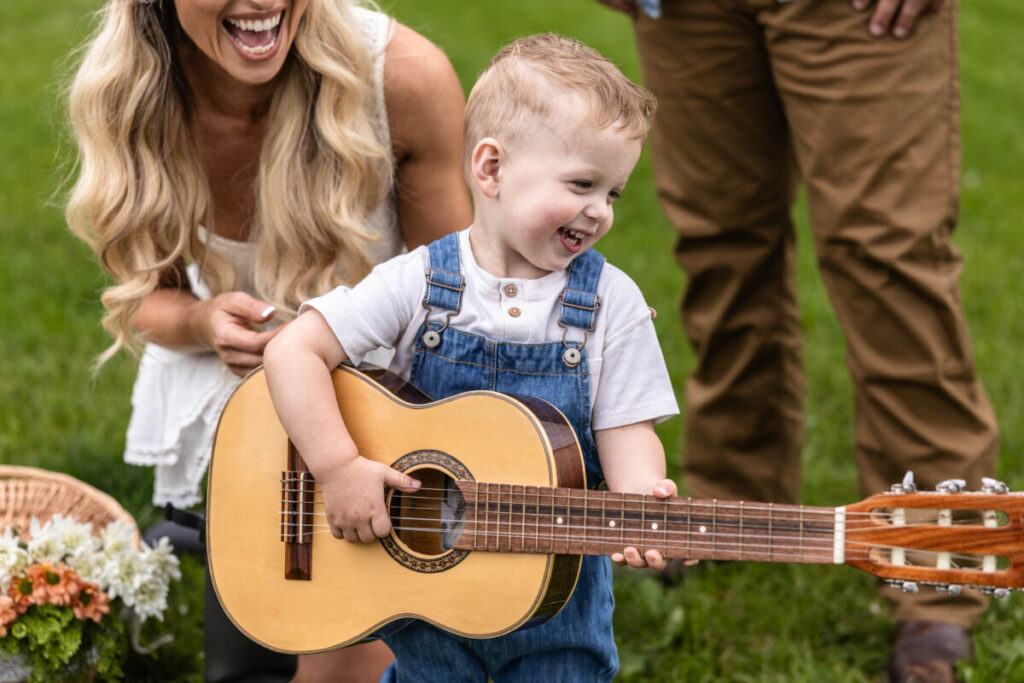 Little boy playing guitar photo session