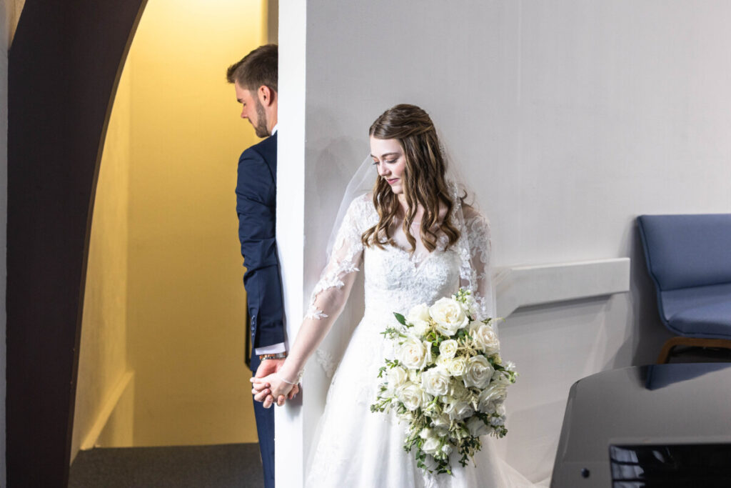 First touch between bride and groom at church wedding in Colorado