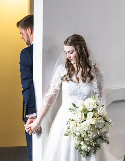 First touch between bride and groom at church wedding in Colorado