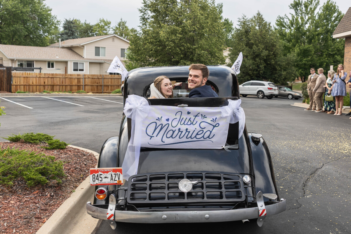 Colorado bride and groom leaving in vintage car