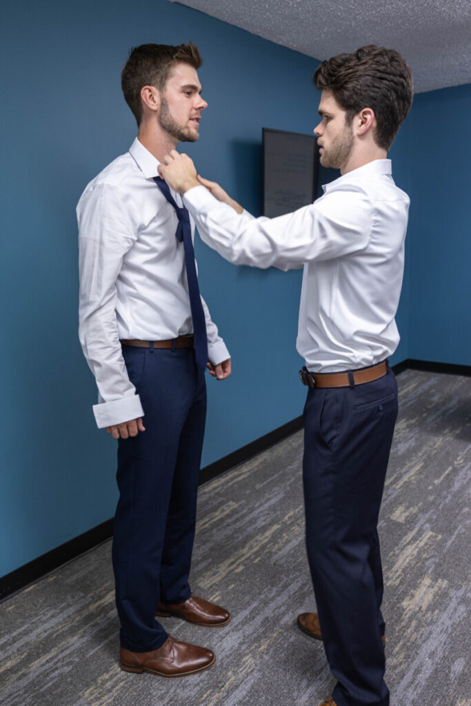 Best man helping groom at wedding in Colorado