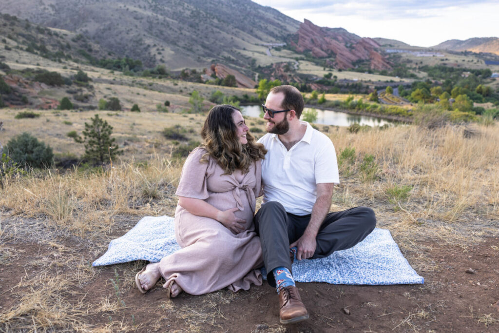 Maternity photographer in Colorado with red rocks and foothills