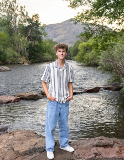 Colorado senior photographer in Golden at sunset with the river and foothills