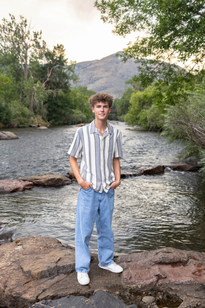 Colorado senior photographer in Golden at sunset with the river and foothills