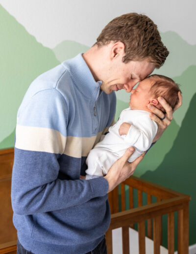 Colorado baby and family photographer with newborn in nursery
