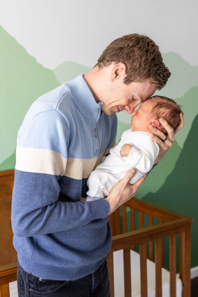 Colorado baby and family photographer with newborn in nursery