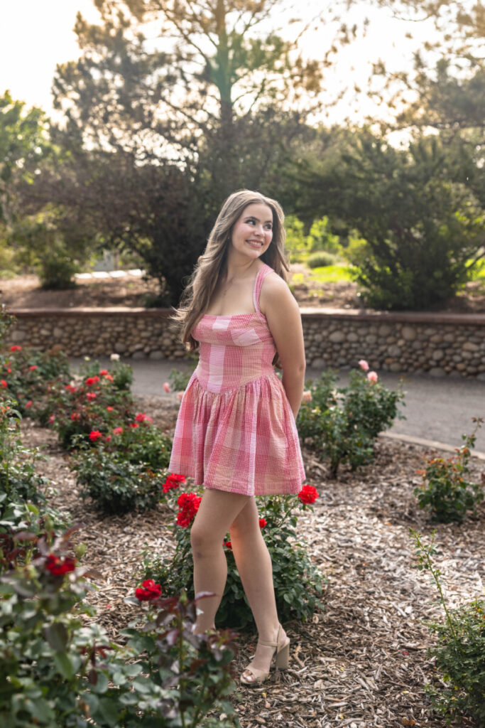 Colorado high school senior photographer with roses at sunset