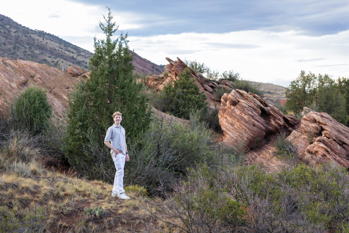 Colorado high school senior photographer with red rocks at sunset