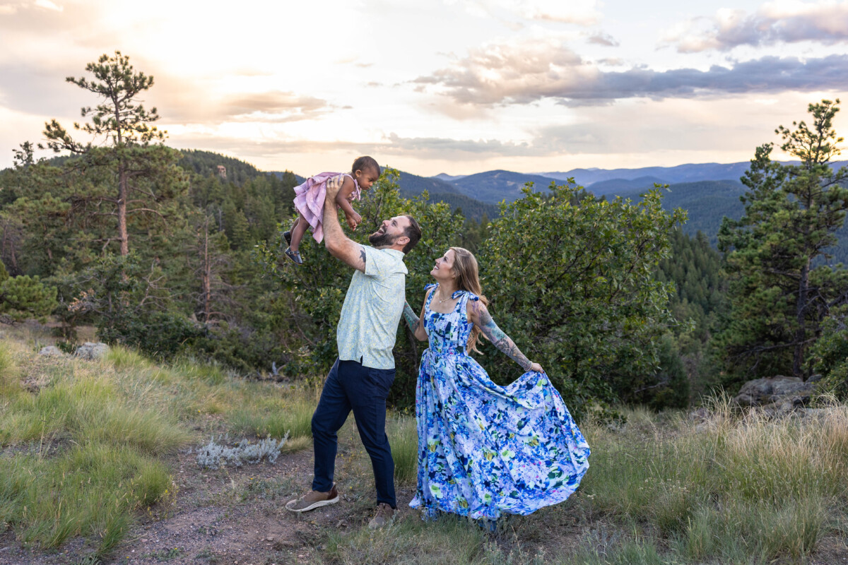 Littleton family photographer in Colorado at sunset with baby in the mountains