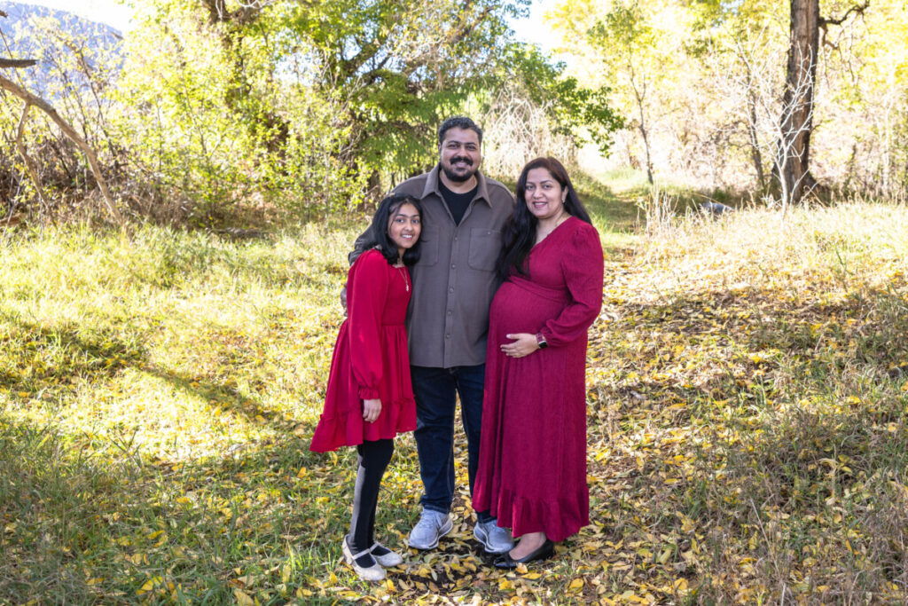 Colorado family photographer in Littleton with fall leaves and children