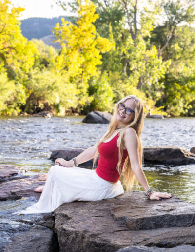 Colorado high school senior photographer in the river at sunset