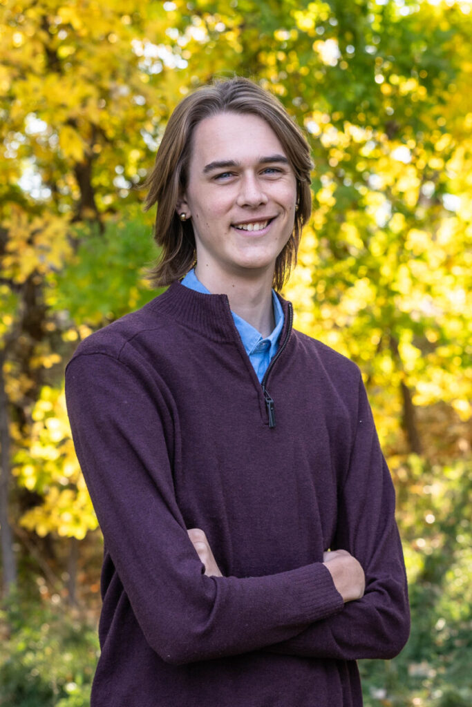 Colorado high school senior photographer for teen boys in the fall leaves