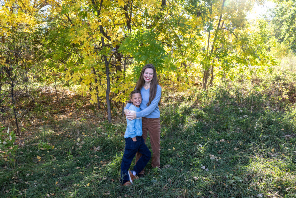 Colorado family photographer in the fall leaves