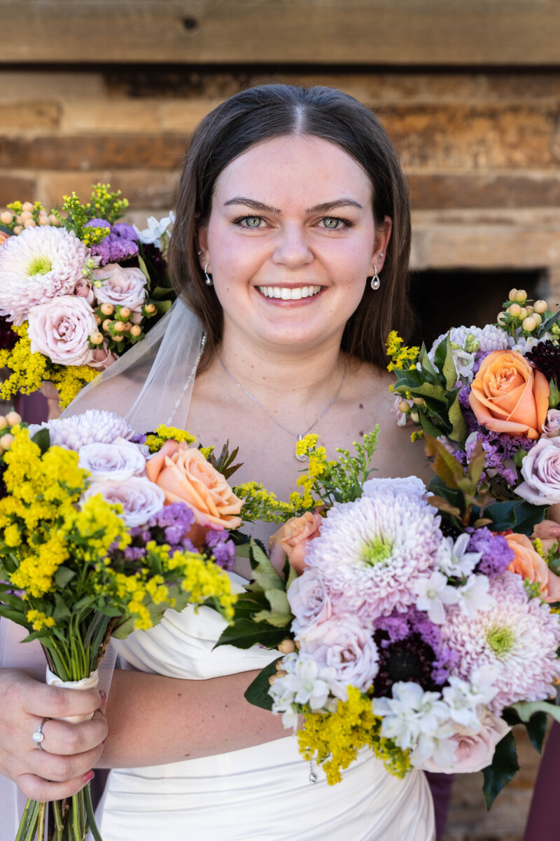 Littleton wedding photographer with bridal party bouquet