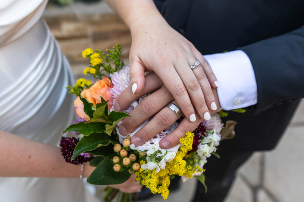 Colorado wedding photographer with bride and groom flowers and rings