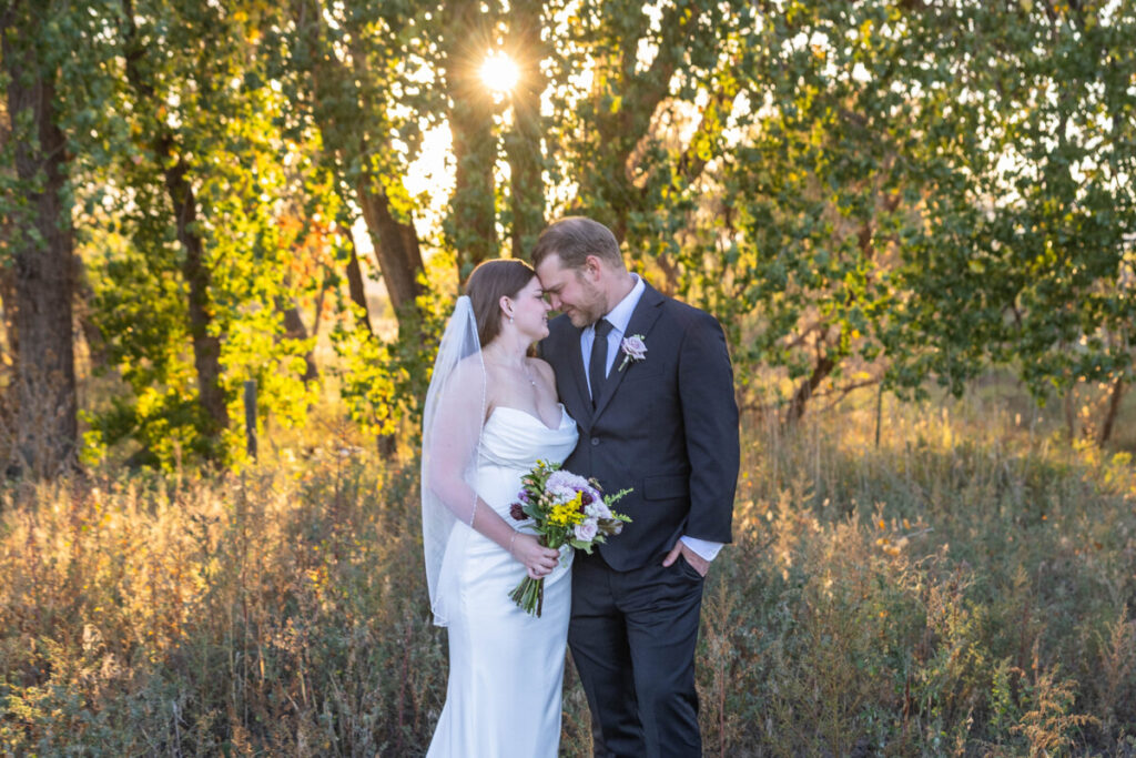 Colorado wedding photographer with bride and groom in the fall light