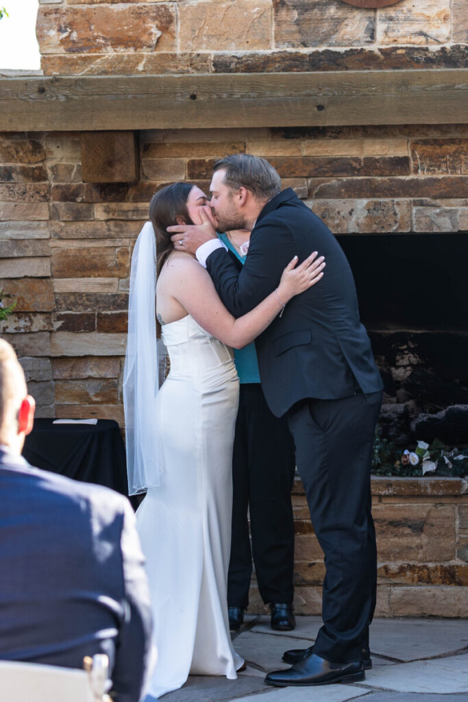 Colorado wedding photographer with first kiss of bride and groom